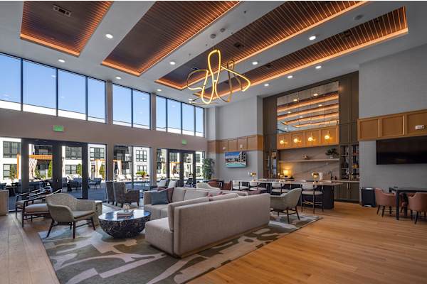 The Plaza at Pinnacle Hills grand lounge with TV and workspace